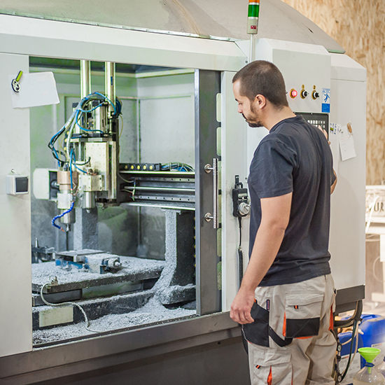 Man operating CNC machine